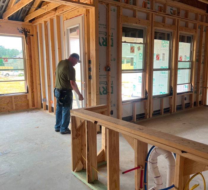 man checking new construction walls